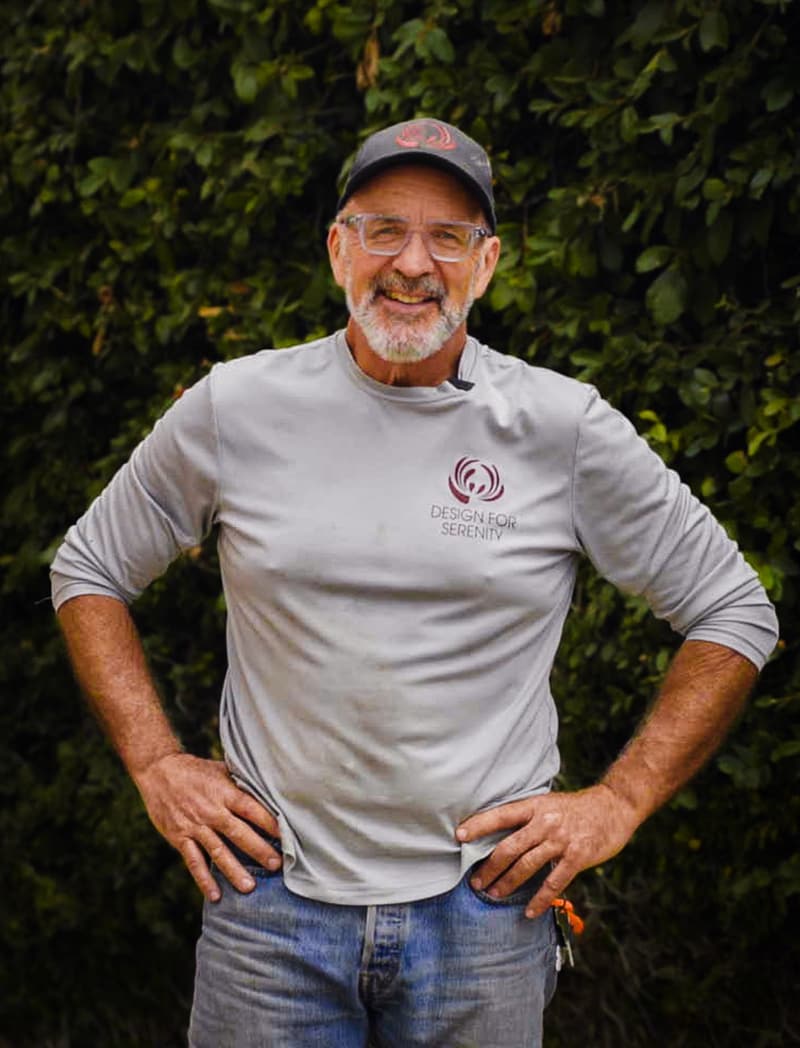 Greg Eubanks, cofounder of Design for Serenity, smiling in a company shirt